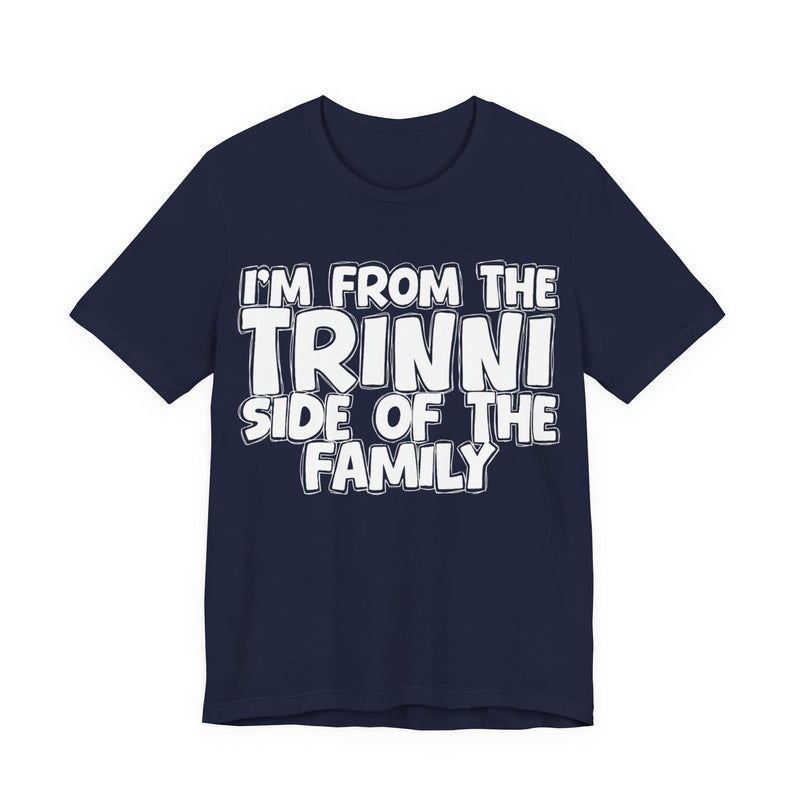 Navy t-shirt with 'I'M FROM THE TRINNI SIDE OF THE FAMILY' in white hand-drawn bubble lettering on the chest, front flat-lay mockup view.