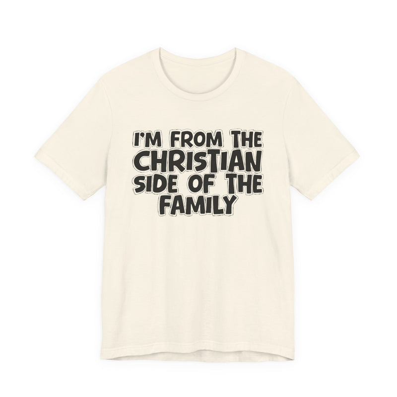 Natural t-shirt with the "I'M FROM THE CHRISTIAN SIDE OF THE FAMILY" statement design in white outlined block lettering, front flat-lay view.