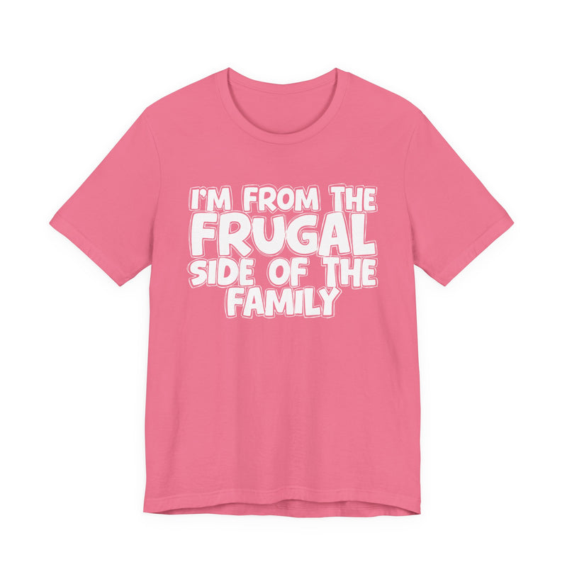 Pink t-shirt with 'I'M FROM THE FRUGAL SIDE OF THE FAMILY' in white hand-drawn bubble lettering on the chest, front flat-lay mockup view.
