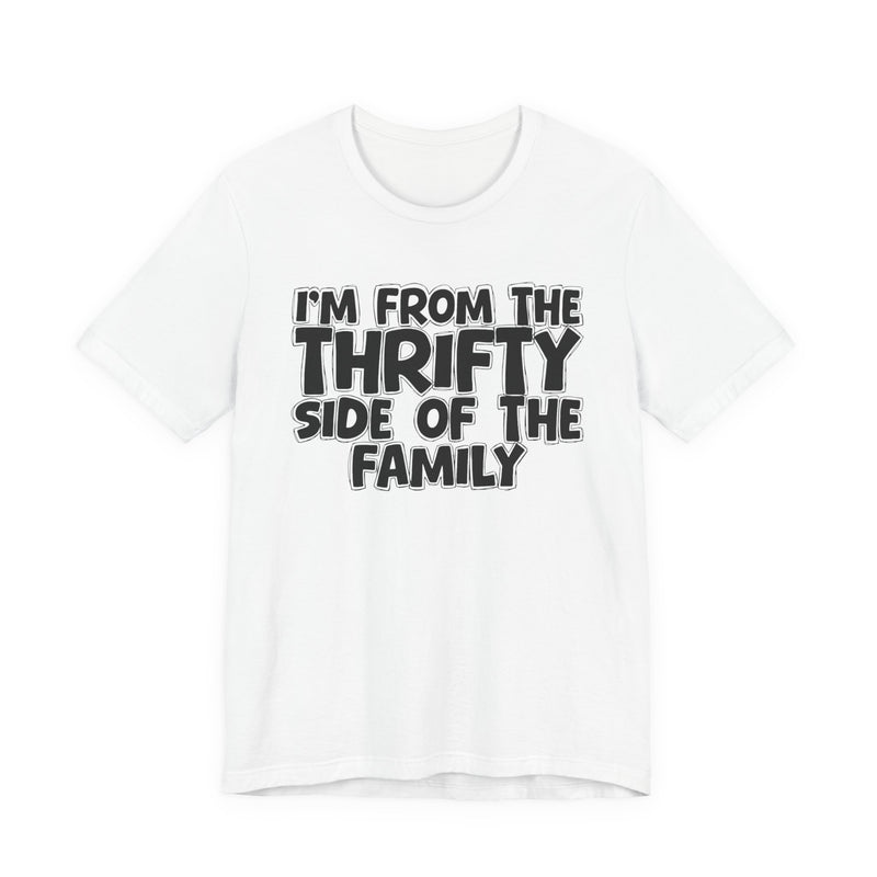 White t-shirt with white outlined bubble lettering reading 'I'M FROM THE THRIFTY SIDE OF THE FAMILY', front flat-lay view.