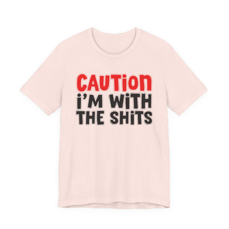 T-Shirt in Soft Pink with lettering reading "CAUTION I'M WITH THE SHITS", front view.