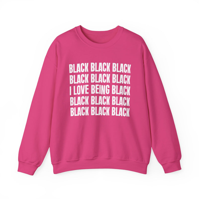 Heliconia sweatshirt with stacked ‘BLACK BLACK BLACK / I LOVE BEING BLACK / BLACK BLACK BLACK’ block text graphic in light-contrast print, front flat-lay mockup view