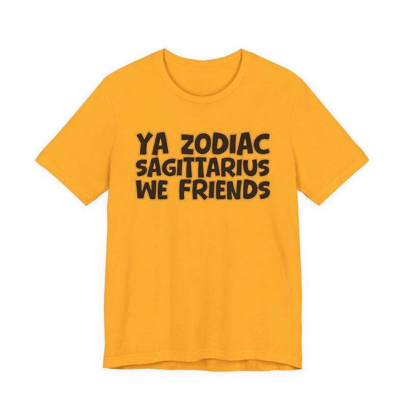 Gold t-shirt with black 'YA ZODIAC SAGITTARIUS WE FRIENDS' cartoon bubble lettering, front flat-lay view.