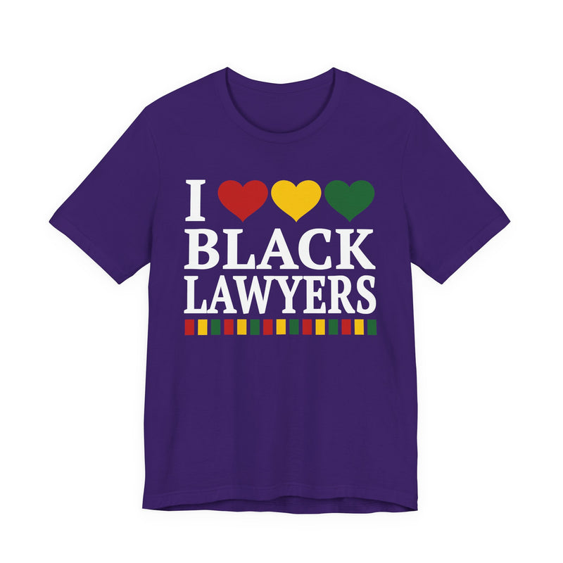 Front flat-lay of the I Love Black Lawyers t-shirt in Team Purple: white 'I' with red, gold, and green hearts above white 'BLACK LAWYERS' collegiate lettering, with a red, gold, and green stripe bar beneath the text.