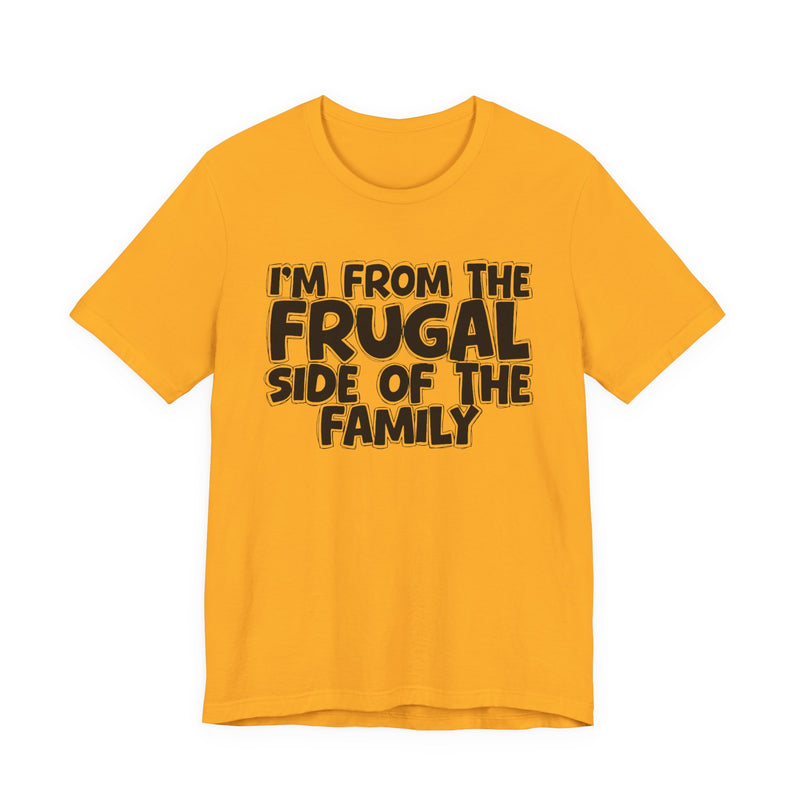 Gold t-shirt with 'I'M FROM THE FRUGAL SIDE OF THE FAMILY' in black hand-drawn bubble lettering on the chest, front flat-lay mockup view.