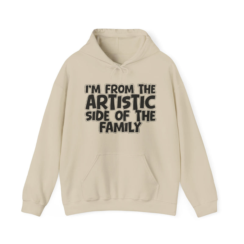 Heliconia hoodie with bold chest statement text reading 'I'M FROM THE ARTISTIC SIDE OF THE FAMILY,' front flat-lay view.