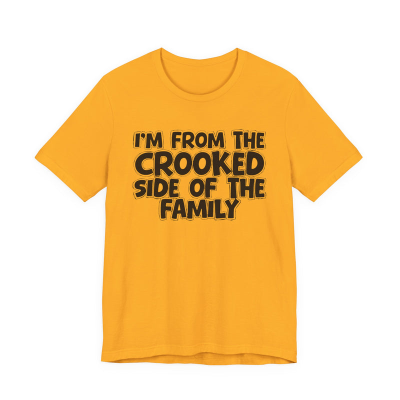 Gold t-shirt, printed with the "I'M FROM THE CROOKED SIDE OF THE FAMILY" statement in bold outlined bubble lettering, front flat-lay view.