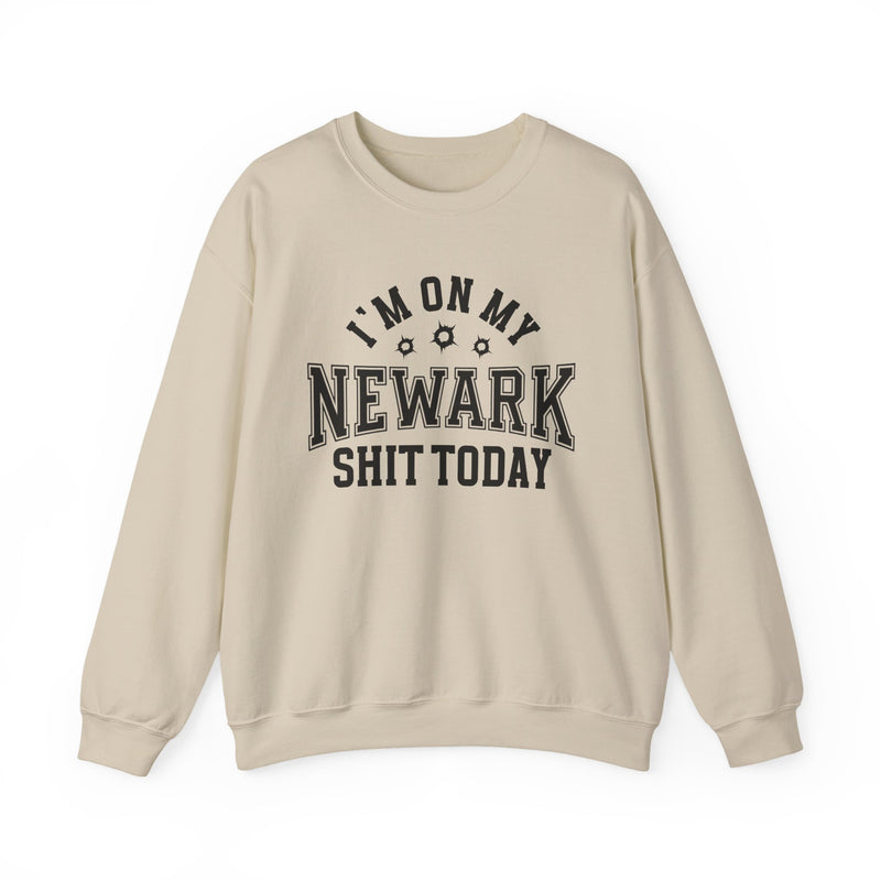 Sweatshirt product with collegiate lettering with bullet-hole accents reading I'M ON MY NEWARK SHIT TODAY, on-model view.