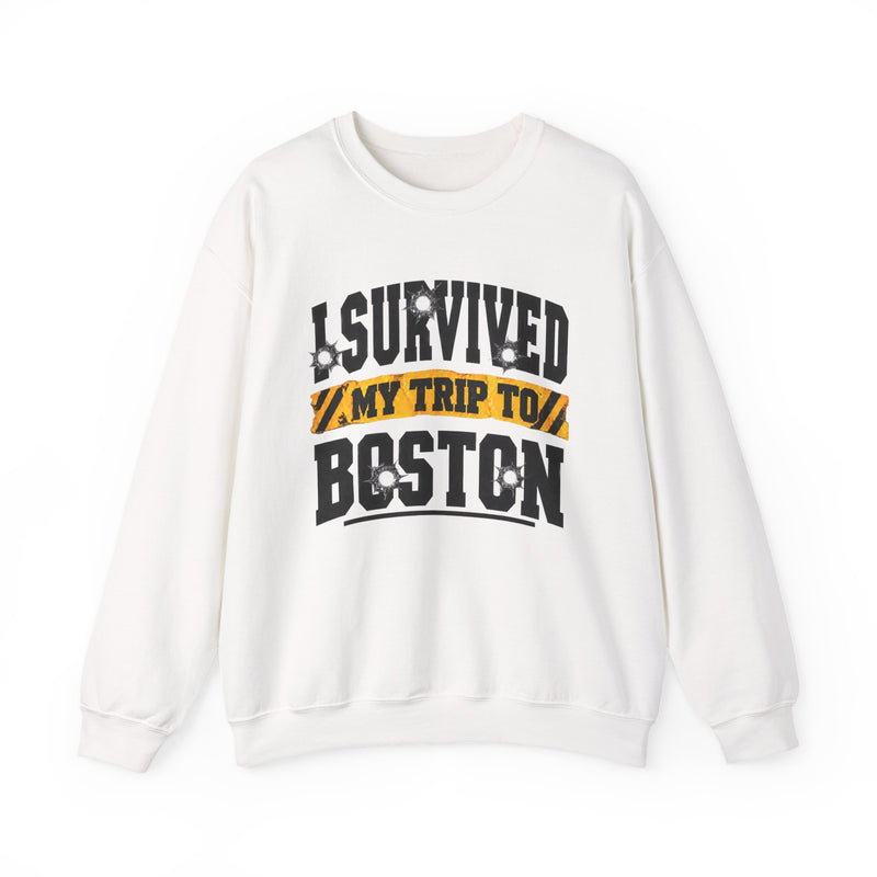White sweatshirt with black block lettering reading I SURVIVED MY TRIP TO PHOENIX, with bullet-hole accents and a yellow caution-tape banner, front flat-lay view.