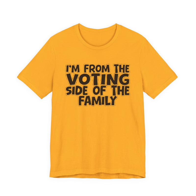 light t-shirt with ‘I’M FROM THE VOTING SIDE OF THE FAMILY’ statement text in bold outline lettering, front flat-lay view.