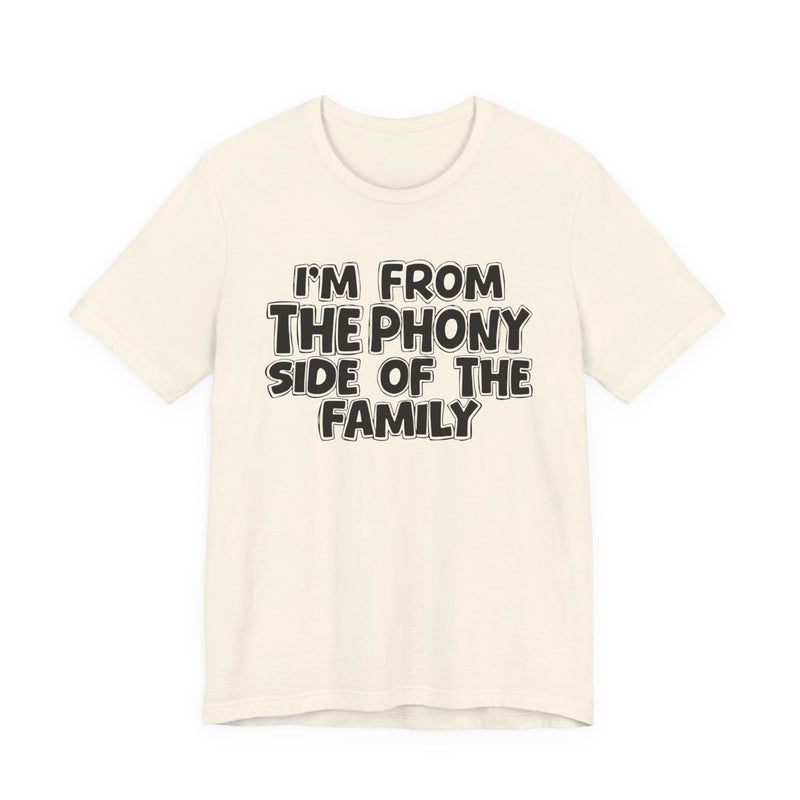 Natural t-shirt with white outlined bubble lettering reading 'I'M FROM THE THE SASSY SIDE OF THE FAMILY', front flat-lay view.