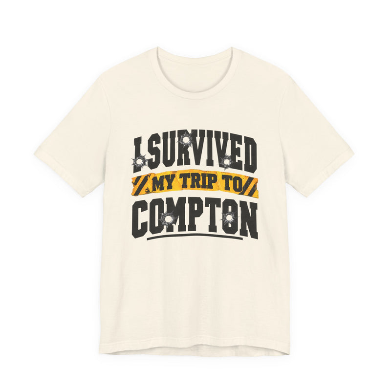 T-Shirt with collegiate lettering reading I SURVIVED MY TRIP TO COMPTON, front view.