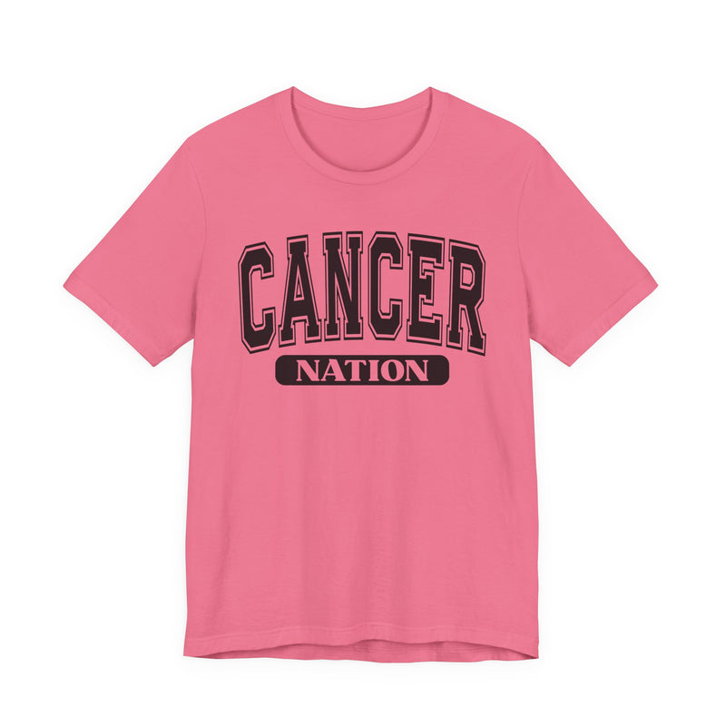 Hot pink t-shirt with black arched CANCER collegiate lettering over a white NATION pill badge, front flat-lay view.