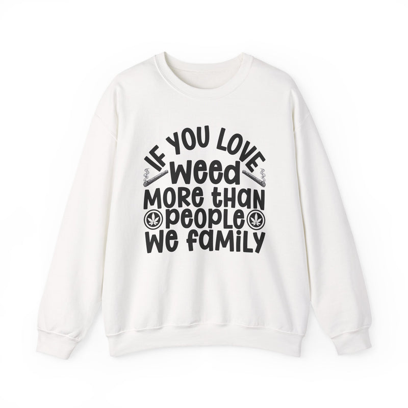 If You Love Weed More Than People We Family — Sweatshirt fabric detail close-up: IF YOU LOVE WEED MORE THAN PEOPLE WE FAMILY in white playful lettering with joint and leaf graphics — white playful lettering with joint and leaf graphics on olive. Street Talk Designs 420-friendly statement apparel.