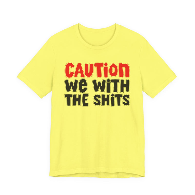 T-Shirt in Yellow with lettering reading "CAUTION WE WITH THE SHITS", front view.