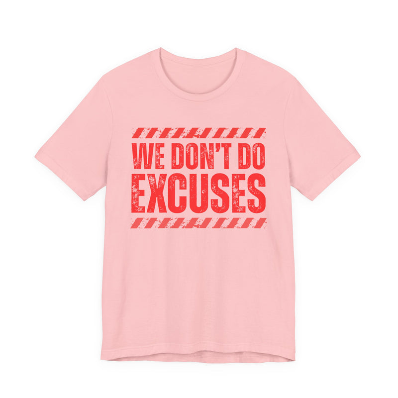 Light pink t-shirt with red bubble lettering reading WE DON'T DO EXCUSES, front view.