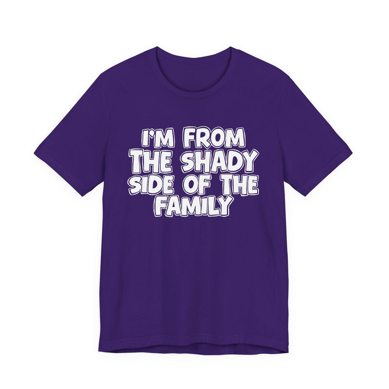 dark t-shirt with ‘I’M FROM THE SHADY SIDE OF THE FAMILY’ statement text in bold outline lettering, front flat-lay view.