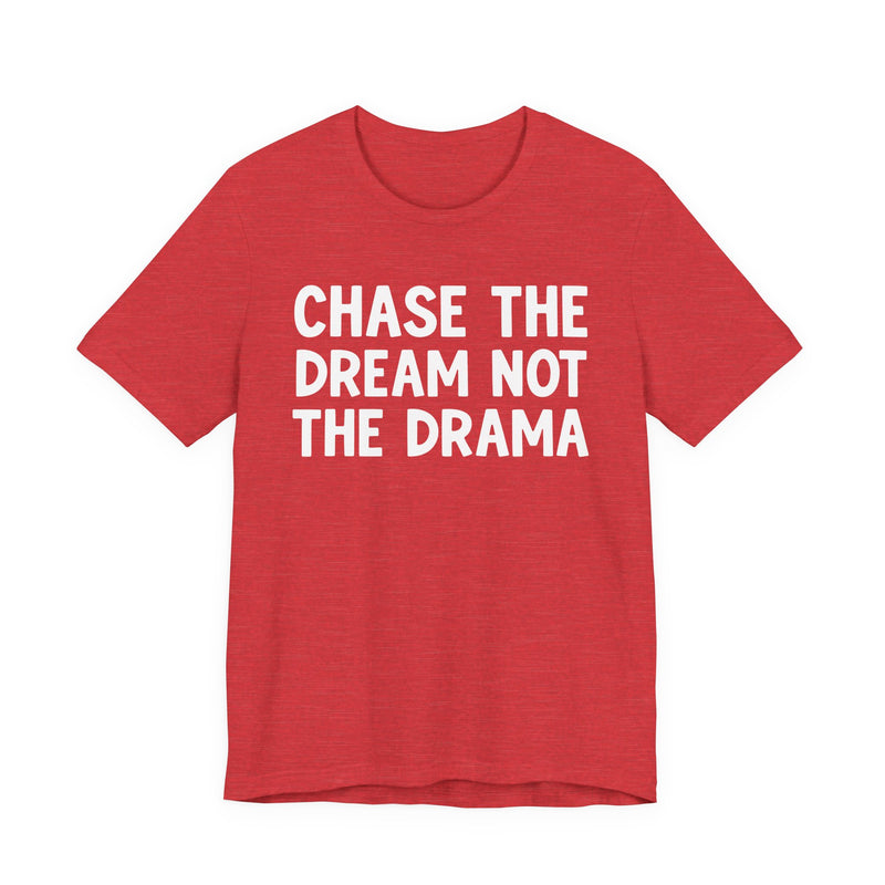 Red t-shirt with white bold statement lettering reading CHASE THE DREAM NOT THE DRAMA, front flat-lay view.