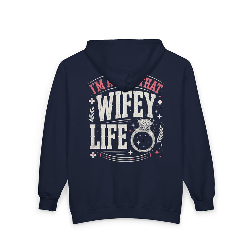 Navy zip hoodie with white and pink western lettering reading "I'M ABOUT THAT WIFEY LIFE", back flat-lay view.
