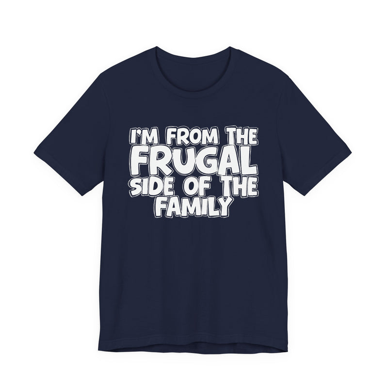 Navy t-shirt with 'I'M FROM THE FRUGAL SIDE OF THE FAMILY' in white hand-drawn bubble lettering on the chest, front flat-lay mockup view.