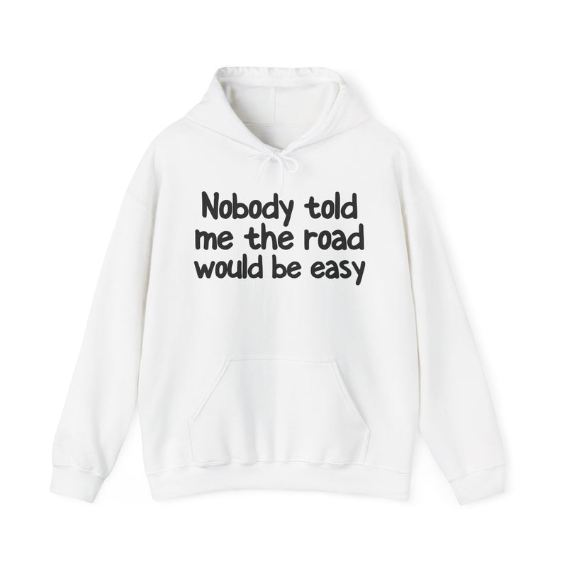 Hoodie with text design reading “NOBODY TOLD ME THE ROAD WOULD BE EASY”, front view
