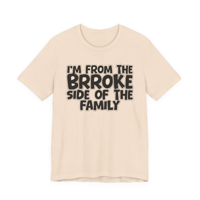 Natural t-shirt with 'I'M FROM THE BRROKE SIDE OF THE FAMILY' in black hand-drawn bubble lettering on the chest, front flat-lay mockup view.