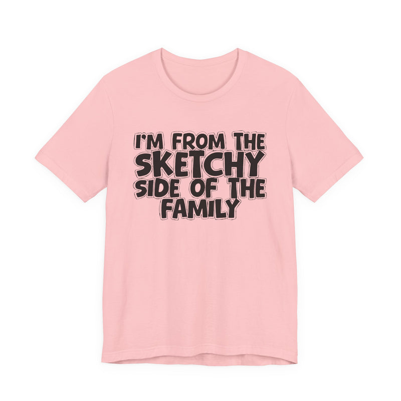 Pink t-shirt with the "I'M FROM THE SKETCHY SIDE OF THE FAMILY" statement design in white outlined block lettering, front flat-lay view.