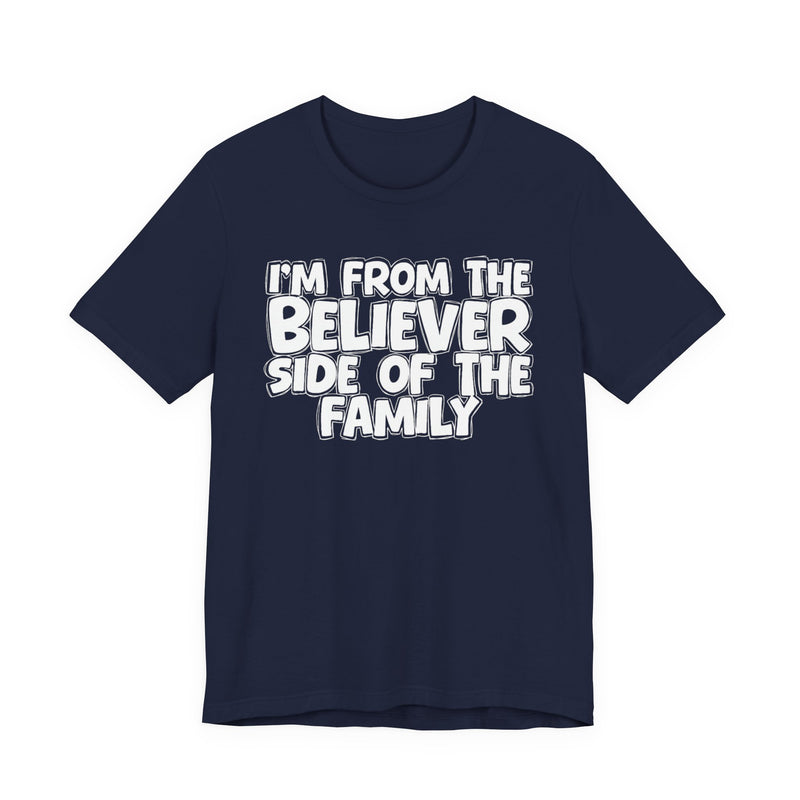 Navy t-shirt with white outlined bubble lettering reading 'I'M FROM THE BELIEVER SIDE OF THE FAMILY', front flat-lay view.