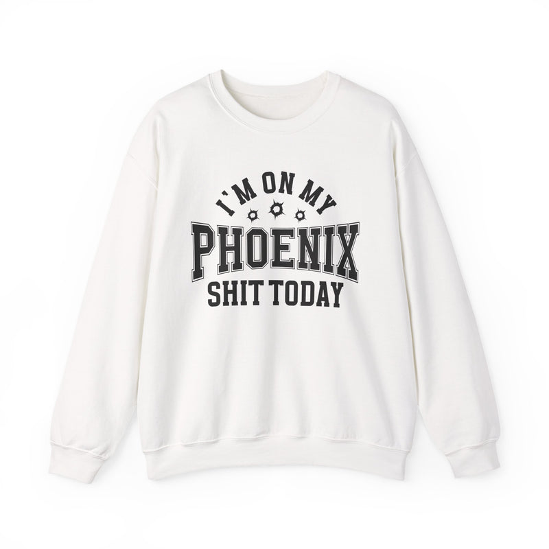 White sweatshirt with black varsity block lettering reading I'M ON MY PHOENIX SHIT TODAY, with bullet-hole accents, front flat-lay view.