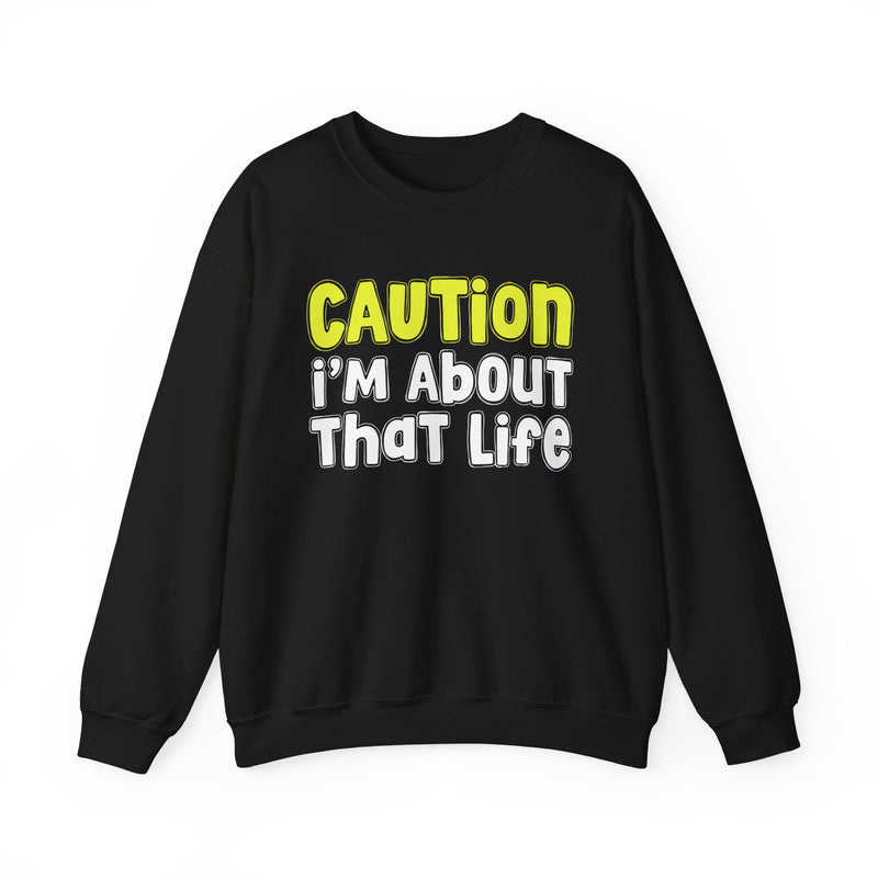 Sweatshirt in Black with lettering reading "CAUTION I'M ABOUT THAT LIFE", front view.