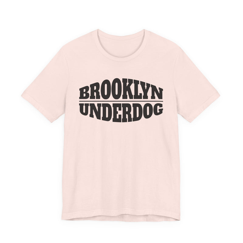 light pink T-shirt with black arched BROOKLYN and inverted-arch UNDERDOG collegiate print, front flat-lay view