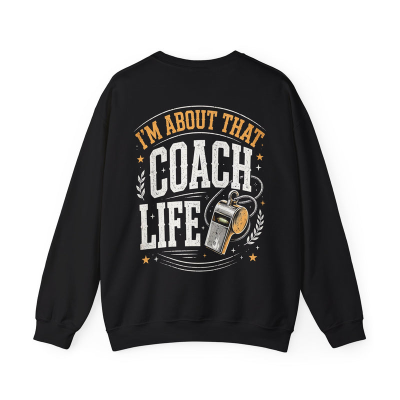 Black sweatshirt with white and orange distressed trade lettering reading I'M ABOUT THAT COACH LIFE, back view.