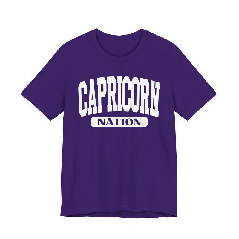 Team Purple t-shirt with white arched CAPRICORN lettering and a NATION pill badge, front view.