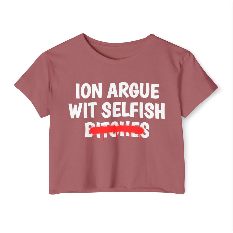 Smoked Paprika crop top with white "ION ARGUE WIT SELFISH BITCHES" chest print, red spray-paint strike-through across the last line, front flat-lay view.