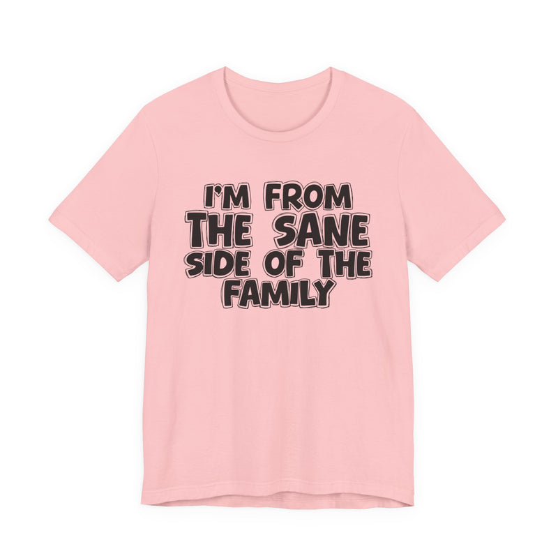 Pink t-shirt, printed with the "I'M FROM THE SANE SIDE OF THE FAMILY" statement in bold outlined bubble lettering, front flat-lay view.