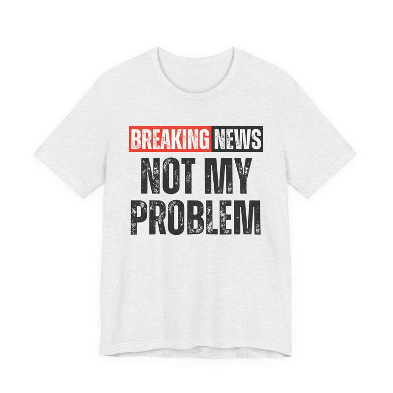 BREAKING NEWS: NOT MY PROBLEM distressed news-bar text design — t-shirt in Soft Cream, front view, product mockup on white background