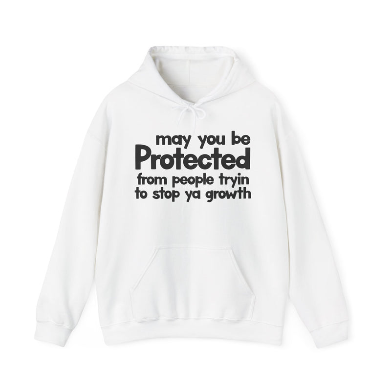 May You Be Protected From People Tryin To Stop Ya Growth — Hoodie fabric detail close-up: MAY YOU BE PROTECTED FROM PEOPLE TRYIN TO STOP YA GROWTH in bold statement lettering. Street Talk Designs protection statement apparel.