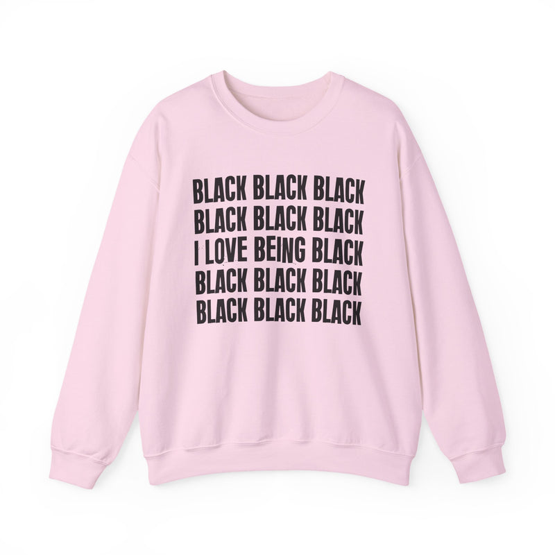 Light Pink sweatshirt with stacked ‘BLACK BLACK BLACK / I LOVE BEING BLACK / BLACK BLACK BLACK’ block text graphic in dark-contrast print, front flat-lay mockup view
