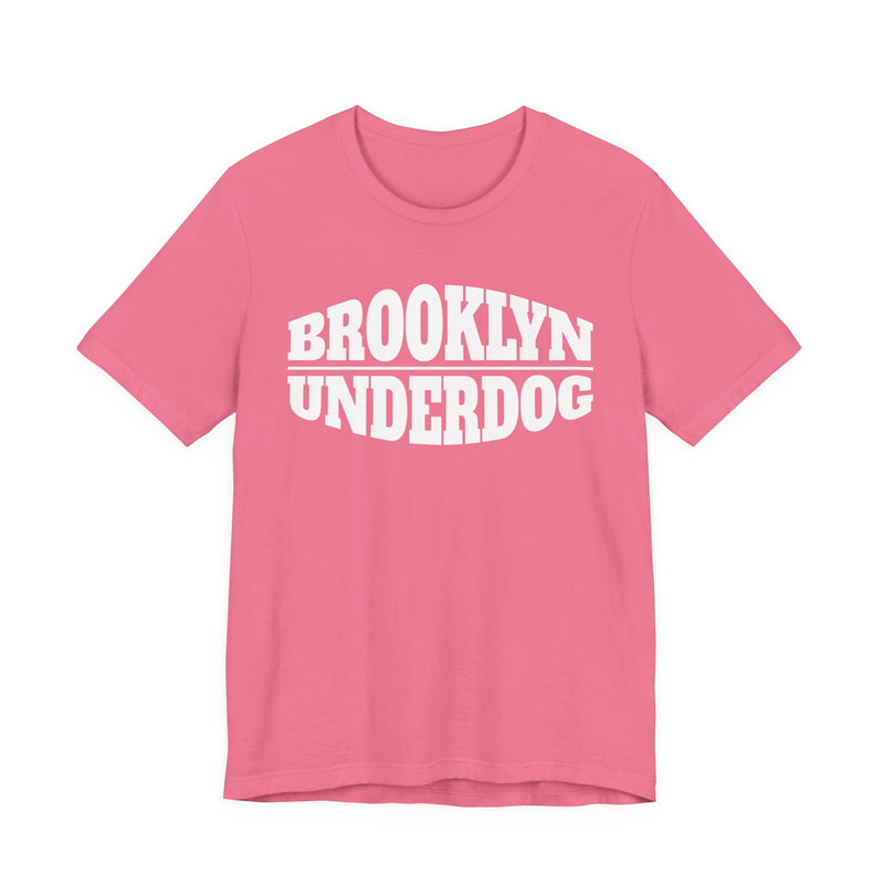 bright pink T-shirt with white arched BROOKLYN and inverted-arch UNDERDOG collegiate print, front flat-lay view