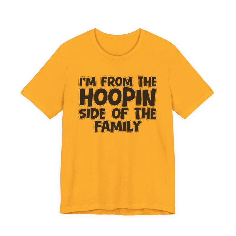 Gold t-shirt with white outlined bubble lettering reading 'I'M FROM THE HOOPIN SIDE OF THE FAMILY', front flat-lay view.