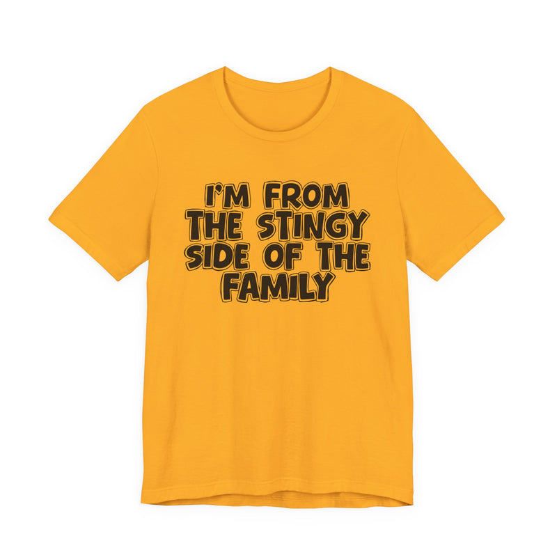 Gold t-shirt, printed with the "I'M FROM THE STINGY SIDE OF THE FAMILY" statement in bold outlined bubble lettering, front flat-lay view.