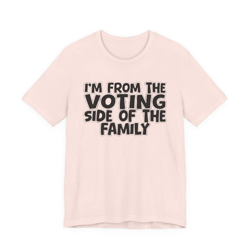 light t-shirt with ‘I’M FROM THE VOTING SIDE OF THE FAMILY’ statement text in bold outline lettering, front flat-lay view.