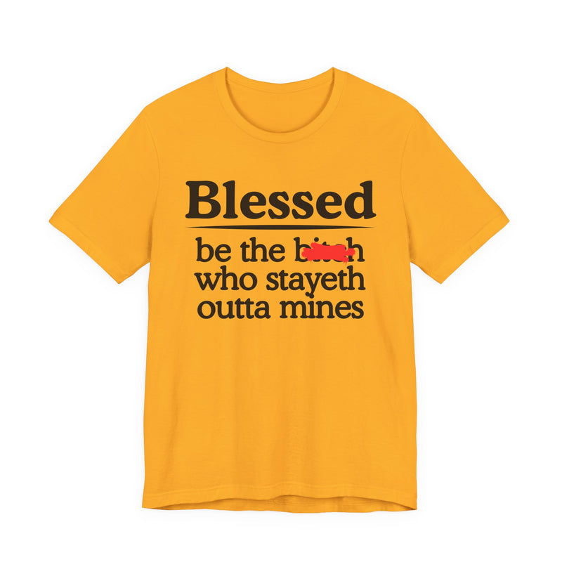 Gold tee with black and white serif lettering reading "Blessed be the b—h who stayeth outta mines", front flat-lay view, with a red redaction mark over the middle word.
