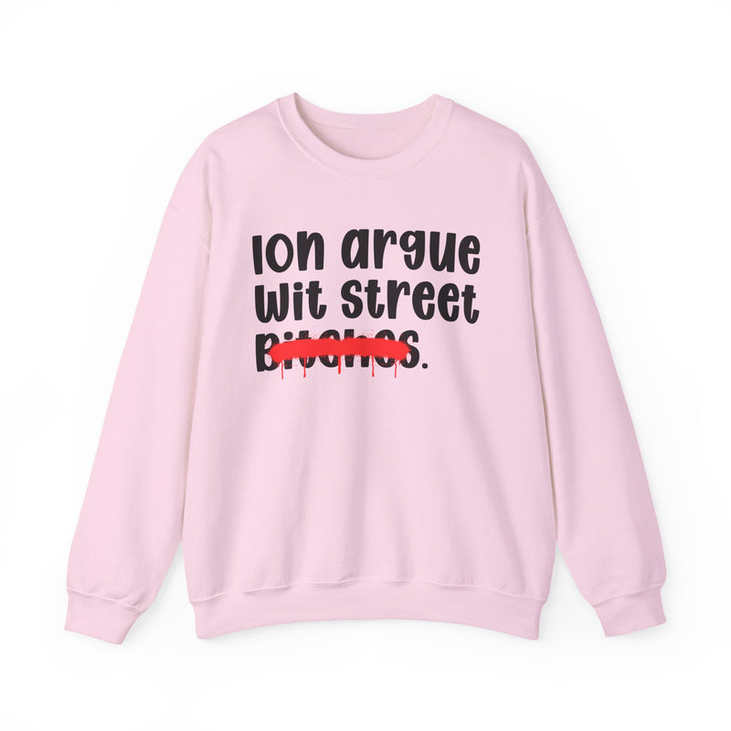 Light pink sweatshirt with black printed statement graphic, front view: "Ion argue" and "Wit street" in rounded chunky lettering over distressed "Bitches." crossed by a red spray-paint strike with paint drips
