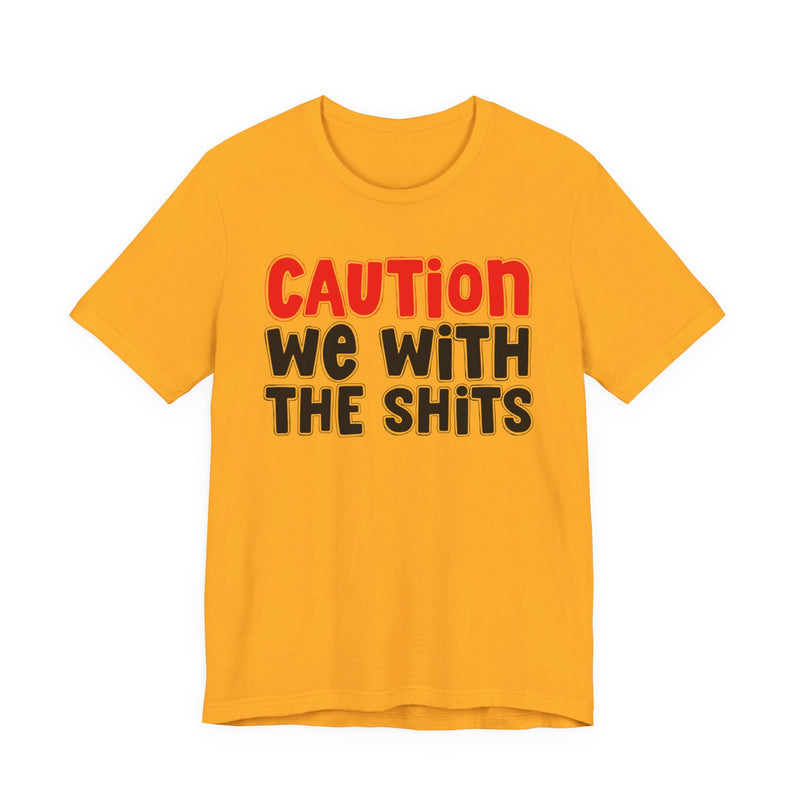 T-Shirt in Gold with lettering reading "CAUTION WE WITH THE SHITS", front view.