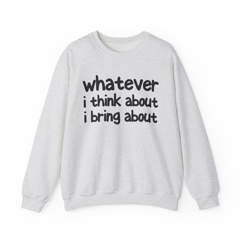 Natural sweatshirt with dark bold manifestation lettering reading WHATEVER I THINK ABOUT I BRING ABOUT, front flat-lay view.