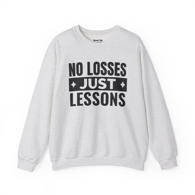 White sweatshirt with black block lettering reading NO LOSSES JUST LESSONS, alternate view.