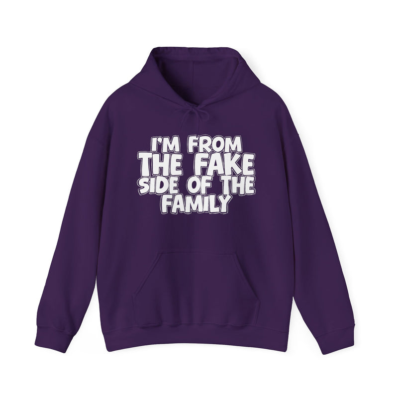 Navy hoodie with "I'M FROM THE FAKE SIDE OF THE FAMILY" in bold white outlined bubble lettering, front flat-lay view