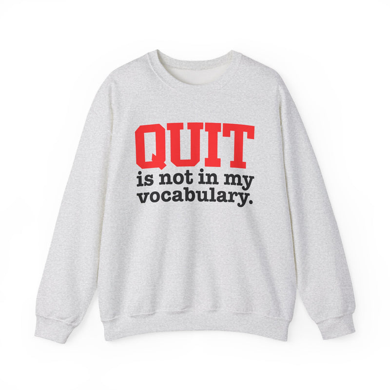 Light Pink sweatshirt with black and red block lettering reading "QUIT is not in my vocabulary.", front flat-lay view.