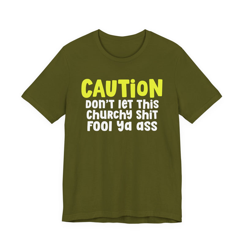 T-Shirt in Olive with lettering reading "CAUTION DON'T LET THIS CHURCHY FOOL YA ASS", front view.